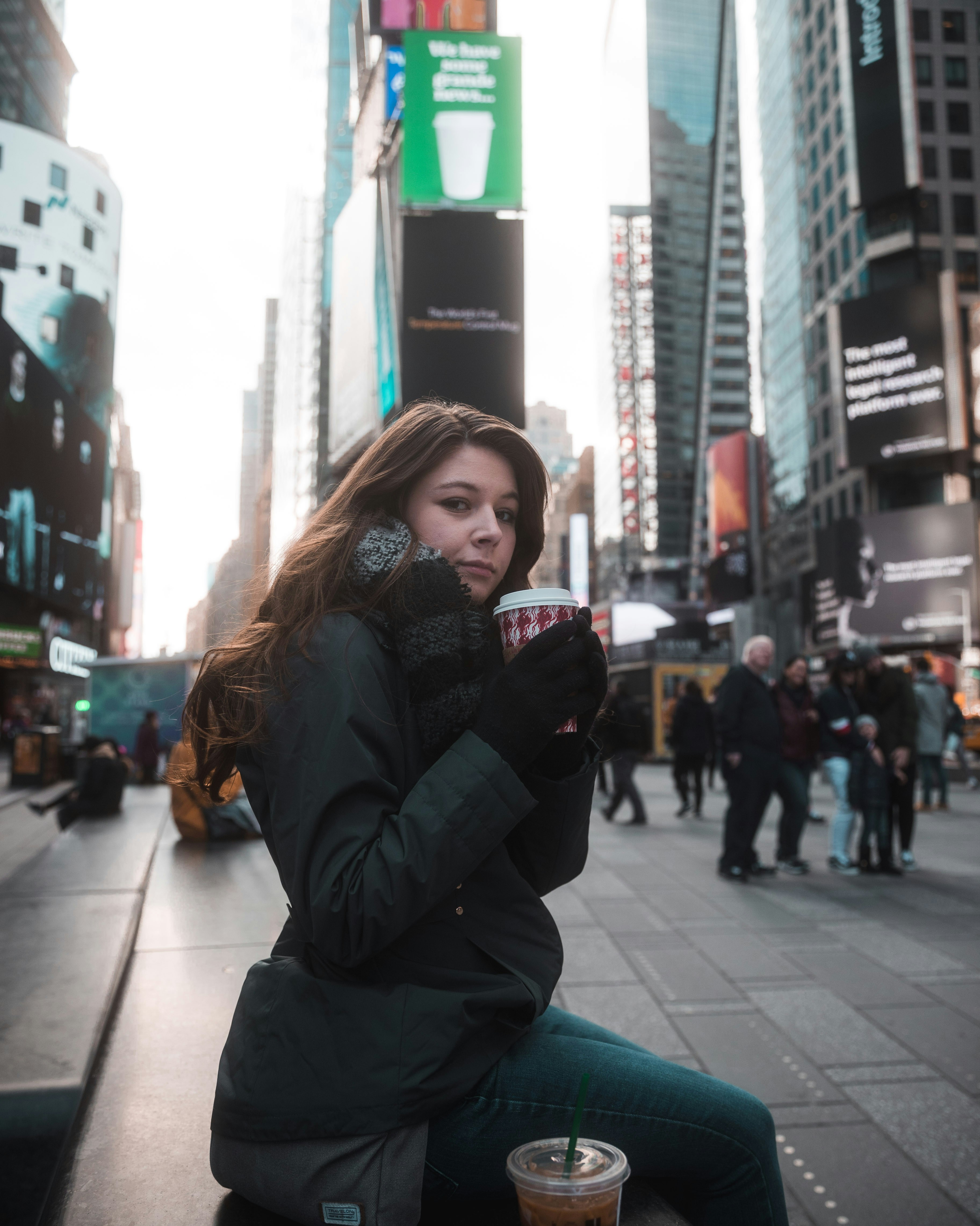 Person holding coffee in a city street